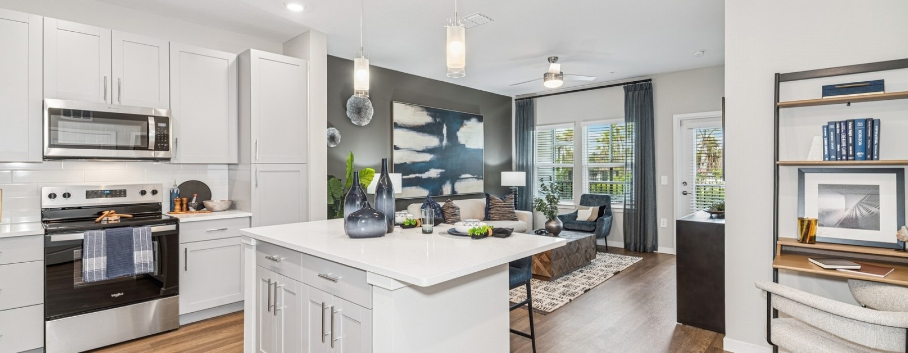 a kitchen island and living room in the background