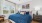 a bedroom with a bed and sidetable and windows