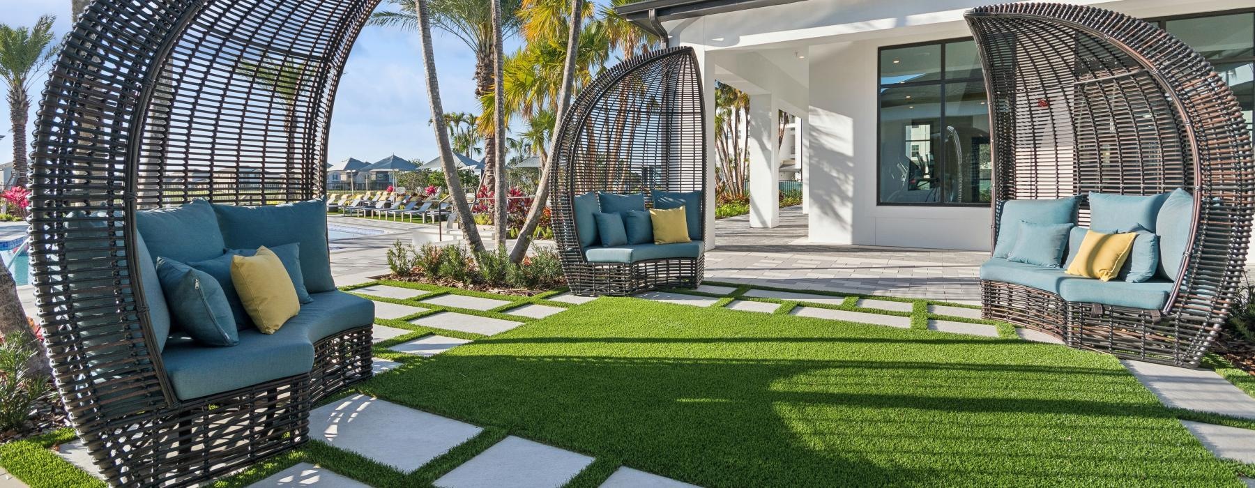 a patio with chairs and shading