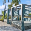 a covered patio deck with trees and blue sky