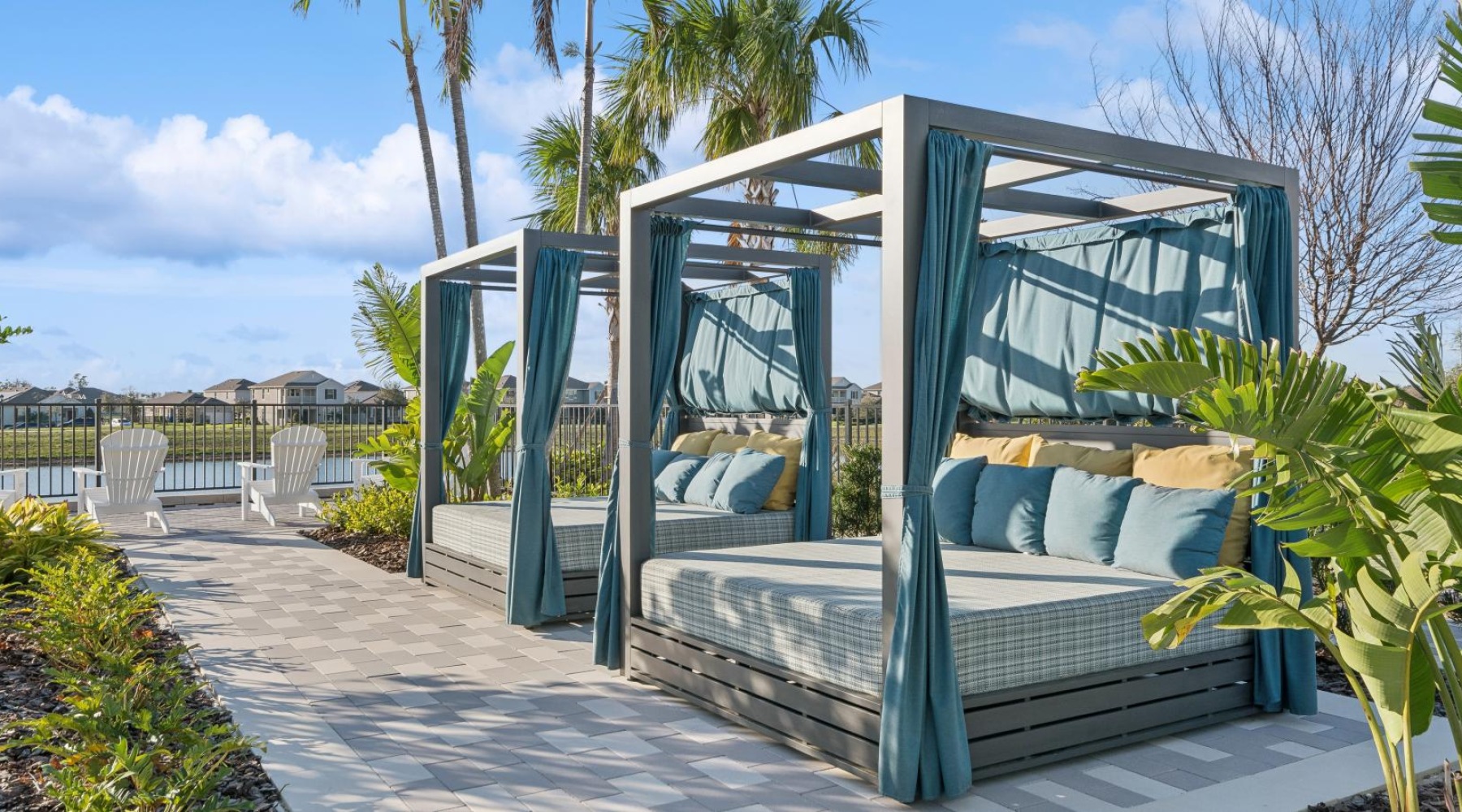 Relax and unwind poolside a covered patio deck with trees and blue sky